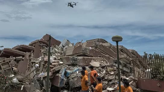 Rescatistas trabajan en medio de escombros tras el terremoto en Venezuela, mientras un dron sobrevuela la zona afectada.